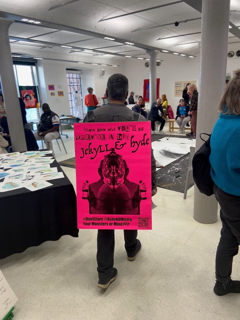 image of the artist at Tate Liverpool wearing a bright pink sandwich board